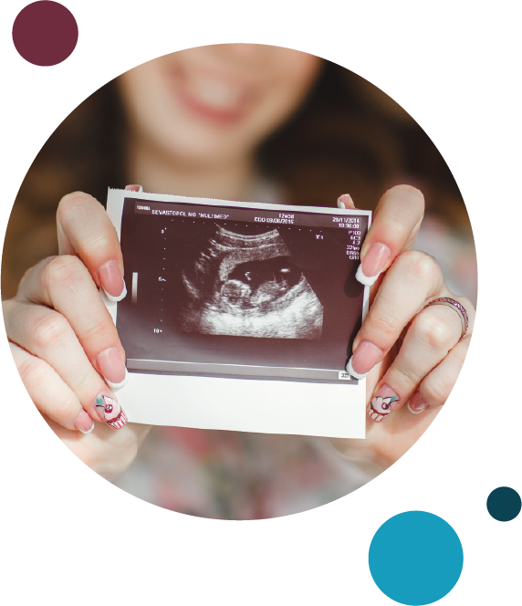 woman holding ultrasound picture