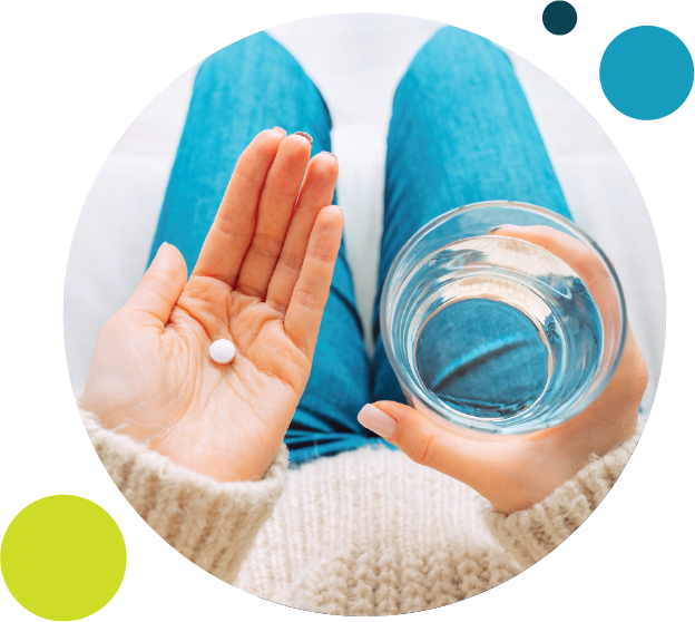 woman holding pill and water