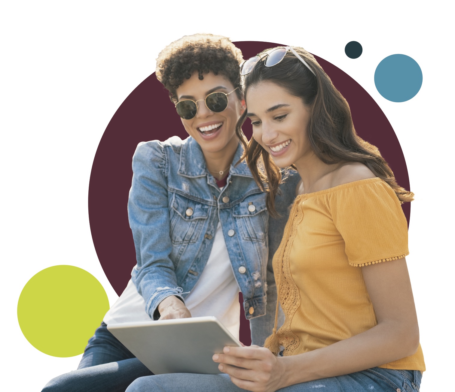 two women smiling at tablet