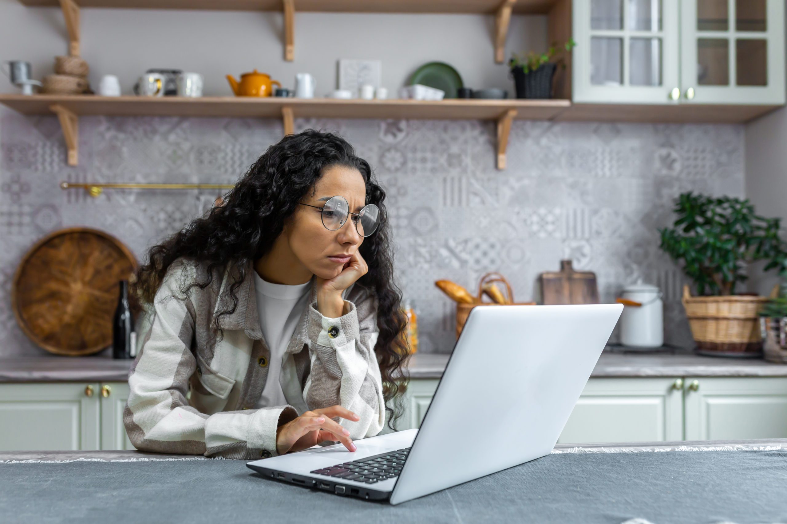 Young Hispanic woman looking at computer screen