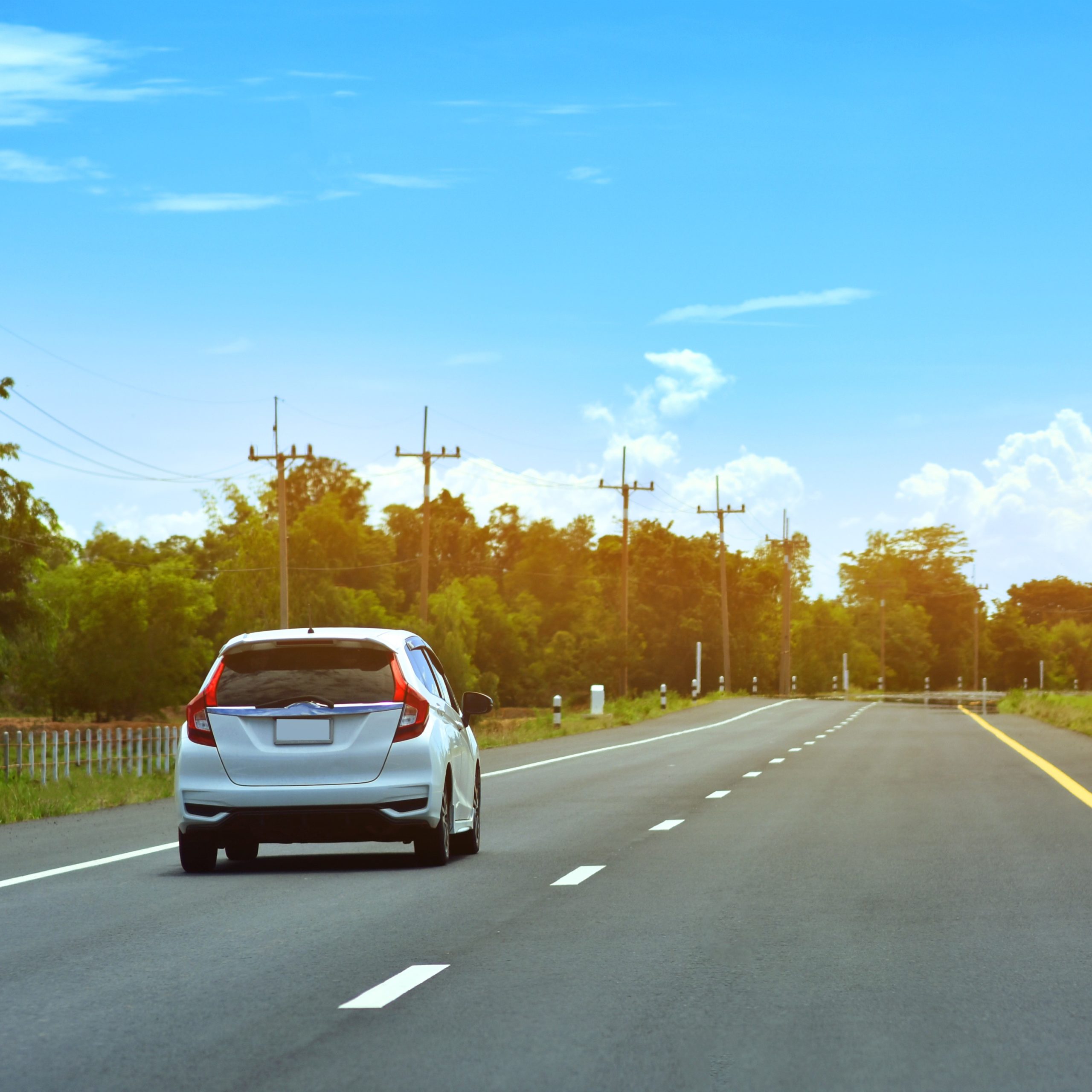 small passenger car driving on road